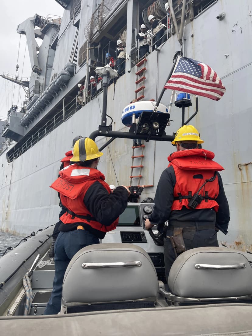 View from boat looking at ladder rope down side of ship