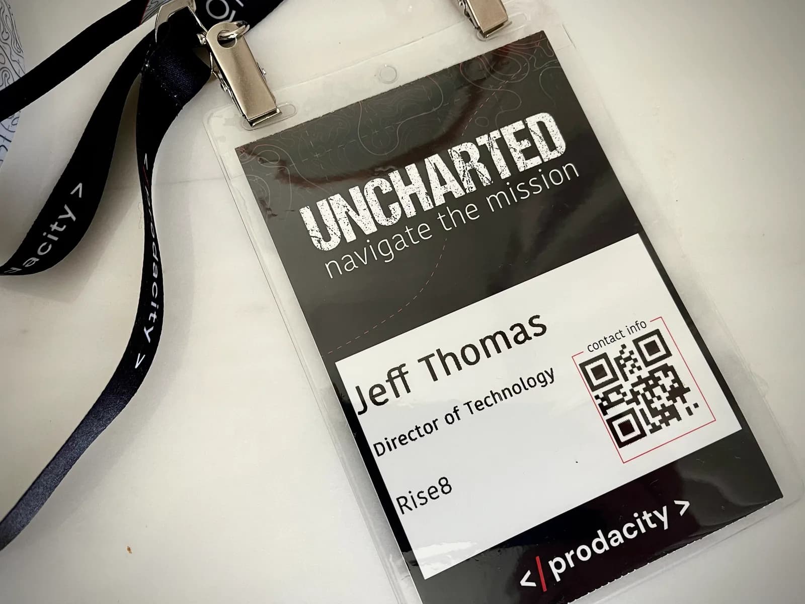Conference badge on a Prodacity lanyard reading Jeff Thomas, Director of Technology, Rise8, over the word UNCHARTED.