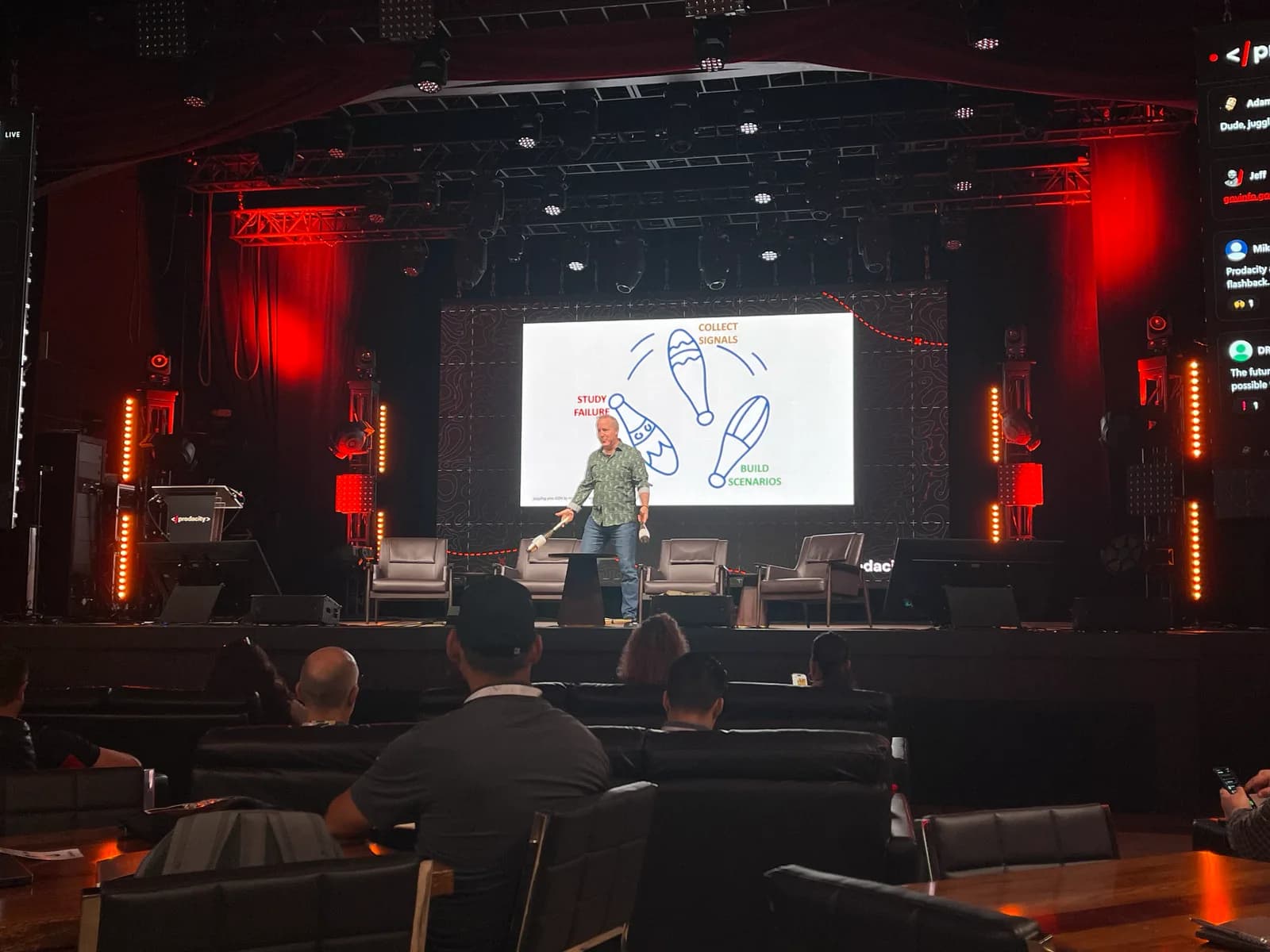 Dan Ward on stage in front of a slide showing juggling pins labeled with his two-word units.